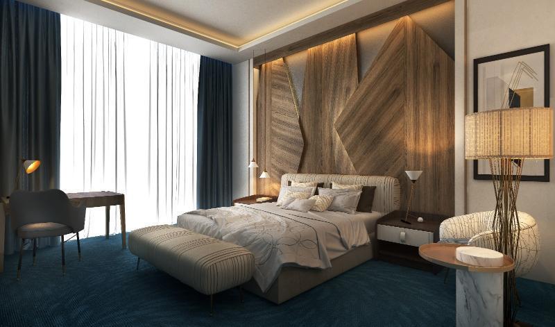 Steigenberger Hotel Doha Exteriör bild The photo shows a modern bedroom with a stylish and contemporary design. The room features a large bed with a textured headboard, complemented by plush bedding. There are two bedside lamps on either side of the bed, and a small seating area with an u